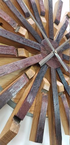 a clock made out of wooden planks on a white surface