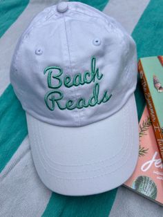 Introducing the Adjustable "Beach Reads" Baseball Hat - your must-have accessory for summer reading adventures. The adjustable strap guarantees a perfect fit, while the charming "Beach Reads" embroidery adds a playful touch to your outfit. Whether lounging by the shore or diving into a novel, this hat combines style and sun protection effortlessly. Perfect for embracing the joy of summer and your love for literature wherever you go! Beach Reads, Reading Adventure, Unique Hats, Beach Reading, Beach Accessories, Summer Reading, A Novel, Baseball Hat, Trucker Cap