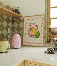 a kitchen counter with toaster, kettle and mugs on it