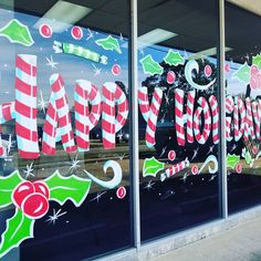 a store front window decorated with christmas decorations and candy canes