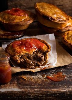 some meat pies and sauce on a table