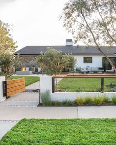 the front yard is clean and ready to be used as an outdoor space for entertaining