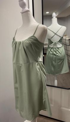 This effortless chic sage green satin dress is the perfect addition to your wardrobe. Featuring a soft, luxurious feel, the dress is designed with a gathered front that accentuates your silhouette, while thin straps cross delicately at the back for a flattering, feminine touch. the adjustable tie ensure a perfect fit, and the lightweight fabric flows beautifully, making it ideal for both casual outings and special occasions. whether you're attending a summer event or looking for a timeless piece to wear on a night out, this dress offers the perfect balance of elegance and comfort. Sage Green Satin Dress, Green Satin Dress, Sage Dress, Alexandria Va, Summer Events, Green Satin, Effortless Chic, Satin Dress, Dress Clothes For Women