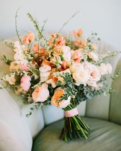 a bouquet of flowers sitting on top of a couch