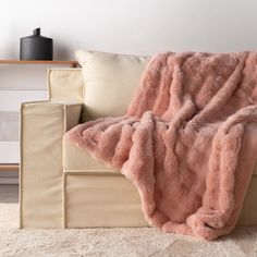 a couch with a pink blanket on top of it