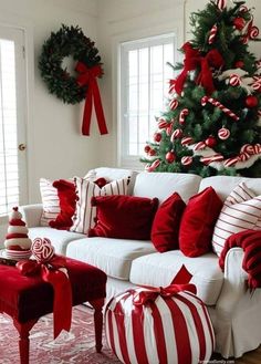 a living room decorated for christmas with red and white decorations on the walls, a large tree in the corner and candy canes all over the couches