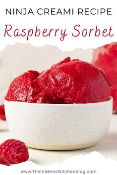 a bowl filled with raspberry sorbet next to some raspberries