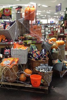 a display in a grocery store filled with lots of food and snacks on wooden crates