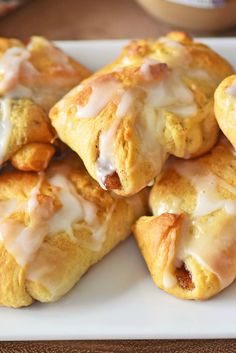 a white plate topped with pastries covered in icing