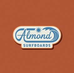 an orange and blue sticker with the words almond surfboards written in white on it