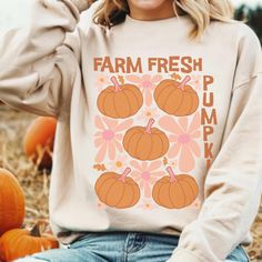 This super-soft fleece-lined Farm Fresh Pumpkins Sweatshirt features a cute abstract floral and pumpkin design and is perfect for Cozy Season! Printed on Gildan unisex sweatshirts for the ultimate in cozy comfort. Please check the size charts for the perfect fit! Details: ✔ 50% ethically grown cotton, 50% polyester ✔ Medium-heavy weight fabric for the perfect amount of warmth ✔ Premium DTG prints - no peeling or cracking ✔ Classic fit in your regular size ✔ Easy care: Machine washable, maintains Trendy Orange Sweatshirt For Fall, Trendy Cozy Fit Sweatshirt For Fall, Graphic Print Cozy Fit Sweatshirt For Fall, Cozy Fall Sweater With Graphic Print, Cozy Fit Graphic Print Sweatshirt For Fall, Cozy Fit Graphic Sweatshirt For Fall, Trendy Orange Relaxed Fit Sweatshirt, Cute Graphic Print Sweater For Fall, Cute Relaxed Fit Sweatshirt For Fall