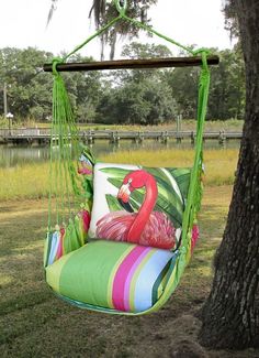 a colorful swing chair hanging from a tree