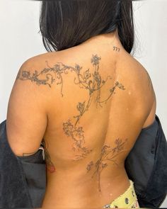 the back of a woman with tattoos on her body