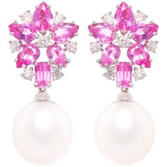 The pink sapphire and South Sea pearl earrings features a flower design on the ear with 9 carats of drop shape and baguette pink sapphires of brilliant crystalline color. The tops suspend 2 lustrous South Sea pearls of 16.5mm diameter. 1.12 carats of round diamonds complete the design. All of our pearls are untreated: their natural color and high luster have not been enhanced in any way. All of our diamonds are of top quality (color, clarity, and cut). The earrings are one-of-a-kind. They were h Pearl Diamond Earrings, Art Deco Drop Earrings, Pearl Earrings Designs, South Sea Pearls Earrings, Sapphire And Diamond Earrings, Pearl And Diamond Earrings, Sea Pearl, Sea Pearls, South Sea Pearls