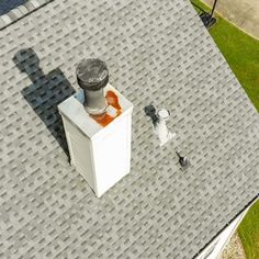 an air conditioner on top of a roof next to a fire hydrant and chimney