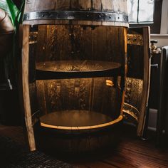 a wooden barrel sitting on top of a hard wood floor