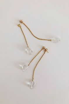 Completely handcrafted in our New York studio, the Polished Quartz 360 Earrings are composed of smooth crystal quartz suspended from 14k gold filled or sterling silver chain.  Designed for a 360 view with front and back strands.  Due to the nature of handmade, each pair is slightly different and unique to you.Ear wires: postsMaterials: 14K Gold Filled or Sterling SilverMeasures approx. 3" in lengthHandmade in New YorkArrives perfectly packaged, ready for gift-giving! Modern Gold Briolette Earrings, Modern Faceted Drop Jewelry, Elegant Clear Crystal Earrings For Everyday, 14k Gold Drop Earrings With Faceted Detail, Modern Crystal Dangle Earrings For Pierced Ears, Gold Faceted 14k Gold-filled Earrings, Modern Clear Drop Jewelry, Clear Minimalist Dangle Earrings, Minimalist Clear Dangle Earrings