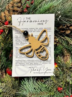 a christmas ornament hanging from a pine tree