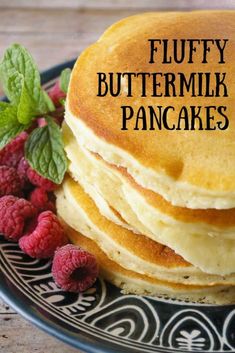 fluffy buttermilk pancakes on a plate with raspberries