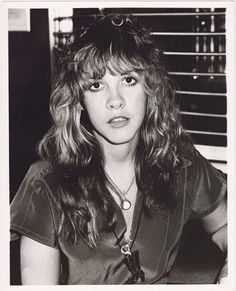 a black and white photo of a woman with long hair