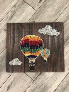 the hot air balloon is painted on wood