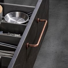 an open drawer with utensils in it