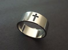 This listing is for a beautiful silver color Stainless Steel cross design ring. The simple ring features a classic silver color with a cut out cross design. This band comes in US/Canada sizes 7 through 11. Type- Ring Sub-Type- Stainless Steel Ring Style- Religious, Classic, Simple Size- US/Canada Sizing, 7-11 Accents- Cut out cross Metal Type- Stainless Steel Color- Silver Why should you shop with Beadology By Heather? -We have a large amount of premium beads and supplies that we offer with your Cross Shaped Stainless Steel Rings For Gifts, Cross-shaped Stainless Steel Ring For Gift, Stainless Steel Cross Rings For Gifts, Stainless Steel Cross-shaped Rings For Gifts, Minimalist Silver Cross Rings, Silver Cross Jewelry For Promise, Steel Cross, Simple Ring, Cross Ring