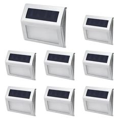 six white solar powered motion activated wall lights