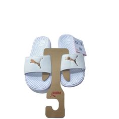 These Brand New White/Creme Women's Hard Foam Puma Logo Slides Are The Perfect Combination Of Style And Comfort. With A Uk Shoe Size Of 7 And A Us Shoe Size Of 9us , These Athletic Sneakers Are Suitable For Gym And Training, Walking, Beach, School, Golf, Typing, Yoga, Fishing, Hiking, Running & Jogging. The White Slides Feature The Iconic Puma Logo And Are Made With Foam Insoles For Added Cushioning And Support. Whether You're Hitting The Gym Or Running Errands, These Puma Slides Will Keep You L Puma Slides, White Slides, Puma Logo, Pumas Shoes, Athletic Sneakers, Slides, Running Errands, Shoe Brands, Brand New