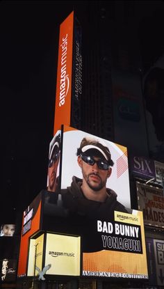 an advertisement on the side of a building in times square, new york city at night