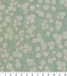 a green and white wallpaper with small leaves on the top, in front of a ruler