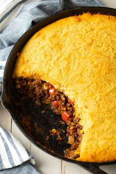 a skillet filled with cornbread and meat