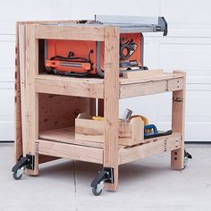 a workbench with tools on it sitting in front of a garage door