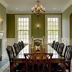 a formal dining room with fireplace and chandelier