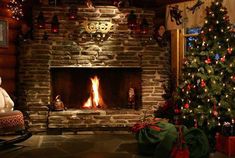 a living room filled with furniture and a fire place next to a christmas tree in front of a stone fireplace