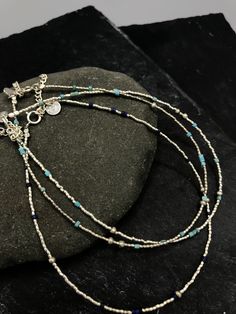 This handmade anklet is composed of small grain silver beads combined with natural lapis lazuli OR turquoise beads, placed randomly along the string. It closes with a simple spring ring and we added 4 cm silver chain that allows for a slight size adjustment. All silver parts are hand crafted in 95-98% Silver by Thai Karen hill-tribe artisans. The Karen are a group of ethnic peoples who reside primarily in southern and southeastern Burma and in northern and north-eastern Thailand. Every piece is Bohemian Sterling Silver Beaded Bracelet With Tiny Beads, Sterling Silver Bohemian Beaded Bracelet, Blue Beaded Bracelets With Silver Beads For Festivals, Blue Round Bead Anklets For Festival, Blue Round Beads Anklet For Festivals, Bohemian Sterling Silver Anklets With Silver Beads, Blue Anklet With Round Beads For Festivals, Blue Beaded Chain Anklets As Gift, Sterling Silver Blue Jewelry With Tiny Beads