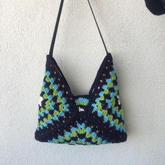 a crocheted purse hanging on the wall