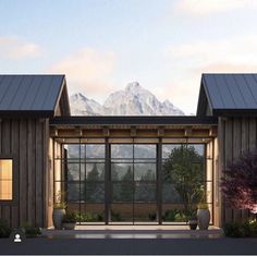 an artist's rendering of a house with large windows and mountains in the background