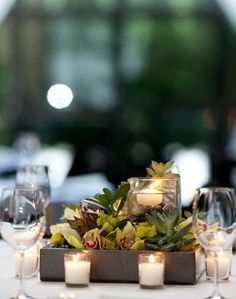 a table with candles and flowers on it