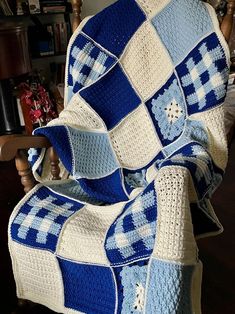 a blue and white blanket sitting on top of a chair