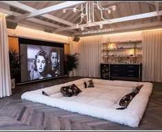 a living room filled with furniture and a flat screen tv mounted to the wall above it