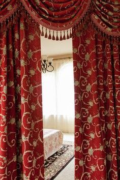 the curtains in this bedroom are red and gold