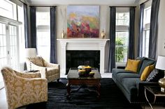 a living room filled with furniture and a fire place in front of a painting on the wall