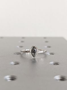 a diamond ring sitting on top of a metal surface