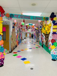 the hallway is decorated with colorful paper decorations and streamers on the ceiling, along with balloons