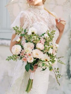 a woman holding a bouquet of flowers in her hand