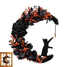 a black cat standing on its hind legs in front of a wreath with orange berries