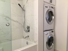 a washer and dryer in a bathroom next to each other