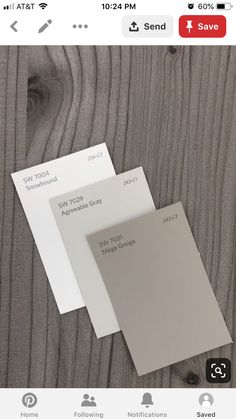 two different shades of gray and white on a wooden surface with the same price tag