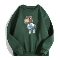 Kanye West Graduation Dropout Bear Sweatshirt,Kanye West Sweatshirt, Ideal for any situation, a unisex heavy blend crewneck sweatshirt is pure comfort. These garments are made from polyester and cotton. This combination helps designs come out looking fresh and beautiful. The collar is ribbed knit, so it retains its shape even after washing. There are no itchy side seams on these sweaters.  .: 50% cotton, 50% polyester .: Medium-heavy fabric (8.0 oz/yd² (271.25 g/m .: Loose fit .: Sewn-in label . Casual Streetwear Sweater With Cartoon Print, Casual Long Sleeve Sweater With Bear Print, Casual Long Sleeve Cartoon Print T-shirt, Green Long Sleeve Top With Cartoon Print, Green Long Sleeve Cartoon Print Top, Casual Cartoon Print Sweatshirt For Streetwear, Casual Long Sleeve Sweatshirt With Cartoon Print, Casual Long Sleeve Cartoon Print Sweatshirt, Long Sleeve Cotton Tops With Bear Print